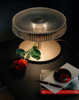 Italamp Gilda table lamp on black side table with rose and books, luxury crystal lighting available at Spacio India for living room or bedroom styling.