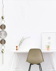 Vertical Italamp Greta Suspension Light displayed next to a sleek white study table, showcasing contemporary Italian design at Spacio India.