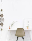 Vertical Italamp Greta Suspension Light displayed next to a sleek white study table, showcasing contemporary Italian design at Spacio India.