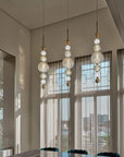 Cluster of Italamp Greta Suspension Lamps in a modern dining space with tall windows, bringing Italian luxury lighting to interiors – Spacio India.