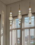 Cluster of Italamp Greta Suspension Lamps in a modern dining space with tall windows, bringing Italian luxury lighting to interiors – Spacio India.