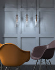 Modern arrangement of Italamp Licio suspension lights with brushed metal and clear glass, showcased in a contemporary space. Spacio India.