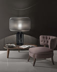 Italamp Odette Odile table lamp with grey diffuser and black base on a wooden coffee table, high-end Italian lighting at Spacio India