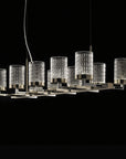 Modern chandelier with crystal-like glass shades on a black background from Italamp available at Spacio in India.