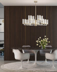 Modern dining room with a chandelier, table, and chairs.