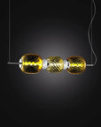 Italamp Rita Suspension Lamp glowing in dark backdrop, featuring golden blown crystal and LED light, Spacio India collection
