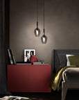 Pair of Italamp Rose Maxi Pendant Lamps installed in a modern bedroom beside a red console, adding a chic Italian lighting accent from Spacio India.