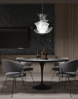 Modern dining room with Italamp Trevi Suspension Lamp from Italy, featured at Spacio India. The sculptural glass design adds elegance above a round dining table.