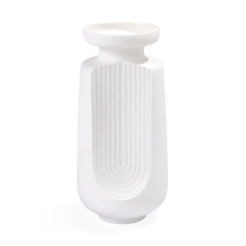 The JA Vase Arco Small White, with its timeless sophistication, stands gracefully on a white surface in this elegant composition by Jonathan Adler.