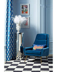 Jonathan Adler Muse Dora Maar Urn glided vase on a silver pedestal beside a chair in an interior available at Spacio India for Luxury Home Collection of Decor Accessories.