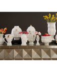 Jonathan Adler Muse Dora Maar Urn glided vase on a console table with other vases collection of glided gold finish available at Spacio India for Luxury Home Collection of Decor Accessories.
