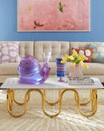 Jonathan Adler Scala Stripe Canister Vase with a porcelain snail sculpture, a vase & books on a coffee table in living room interior available at Spacio India for Luxury Home Decor Accessories collection.