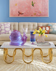 Jonathan Adler Scala Stripe Canister Vase with a porcelain snail sculpture, a vase & books on a coffee table in living room interior available at Spacio India for Luxury Home Decor Accessories collection.