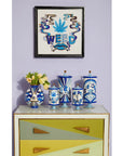 Jonathan Adler Druggist Eye Vase paired with matching blue and white canisters under wall art - iconic design statement in porcelain at Spacio India.