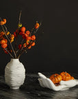 Designer fruit bowl by Jonathan Adler shaped like cupped hands, featuring pumpkins – luxury decor from Spacio India.