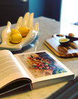 Close-up of Jonathan Adler Gilded Muse Eve Fruit Bowl with lemons, elegant porcelain table decor available at Spacio India.