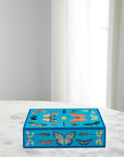 Jonathan Adler Large Lacquer Botanist Box placed on marble surface with colourful butterfly artwork – stylish storage from Spacio India.