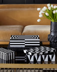 Jonathan Adler Op Art Medium Black & White Box styled on a luxury coffee table with white tulips – available at Spacio India. Features bold black and white lacquer with black lining for elegant interior decor.