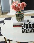 Styled scene with Jonathan Adler Op Art Medium Black & White Box on a white table with books and pink flowers – international brand now at Spacio India.