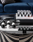 Jonathan Adler Op Art Medium Black & White Box displayed on a black glass table with designer books – a decor essential from Spacio India.