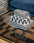 Stacked Jonathan Adler lacquer boxes including the Medium Black & White Op Art Box on a modern table – part of the international decor collection at Spacio India.