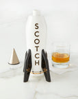 Jonathan Adler Rocket Scotch Decanter in glossy white porcelain with gold detailing, shown open with whiskey glass, available at Spacio India