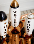 Front view of the Jonathan Adler Rocket Whiskey Mid-Century Decanter crafted from high-fired glossy white porcelain with intricate black, gold, silver, and real gold detailing, available at Spacio India retail stores and online.