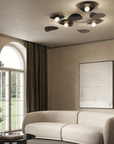 A living room with a white couch, large windows, and a KDLN blown glass lamp.