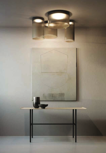 A retro-style table with a KDLN Giass Ceiling Light and a painting on the wall.