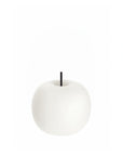 White apple shape table lamp with a black stem on a white background