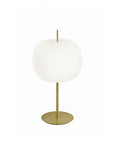 Table lamp with white shade and gold base on a white background