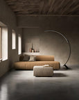 Modern living room with a brown sofa, ottoman, and an extendable floor lamp from KDLN