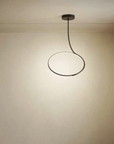 A room with two chairs and a KDLN Poise Ceiling Lamp by KDLN.