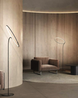 A modern living room with flexible wooden furniture configurations and a KDLN Poise Floor Lamp serving as a light source.
