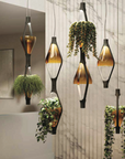 A breath of greenery in a room with a marble floor, adorned with the KDLN Vice Versa Pendant Light suspended from the ceiling.