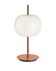 Table lamp with white shade and copper base on a white background