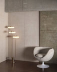 KDLN Tratto Floor Lamp in brass finish on in a contemporary living room corner