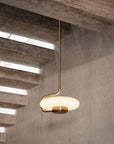 KDLN Tratto Suspension Light Spacio India in brass finish in a contemporary interior below staircase