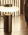 KDLN Tratto Table Lamp in black finish styled on a floor in a luxury contemporary interiors.
