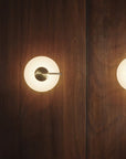 KDLN Tratto Wall in brass finish on wood panelled wall in a modern interior