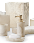 Cream onyx bathroom accessories set from Labrazel including a soap dispenser, soap dish, and containers on a white background.