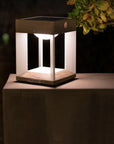 Hexagonal wooden solar lamp on a surface with a dark background