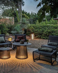 Outdoor patio setting with chairs, tables, and decorative solar lights in a garden from Les Jardins available at Spacio retail stores in Mumbai & Kolkata.