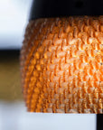 Close-up of a textured orange solar table lamp with a blurred background
