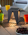 Solar-powered outdoor table lamp on a patio table with fruit and drinks by Les Jardins available at Spacio retail stores in Mumbai & Kolkata.