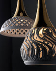 Decorative ceramic pendant lamp with intricate design on a black background