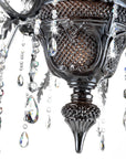 Close-up of an ornate chandelier with crystal elements in black finish