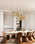 Luxurious dining room featuring the Lustralis modular chandelier by Masiero, available at Spacio retail stores in India - elegant golden chains and soft lighting for refined interiors.