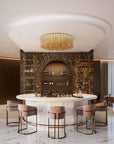 Text: Chic bar space highlighted by the Lustralis ceiling chandelier by Masiero, blending modern design with golden warmth. Available at Spacio in India.