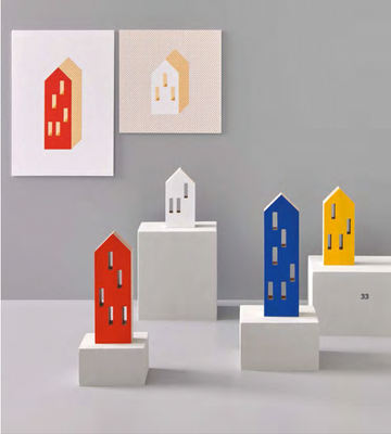 A vibrant collection of Madlab's ML City Opening Pop (4pc set) house sculptures on a table, evoking childhood nostalgia.
